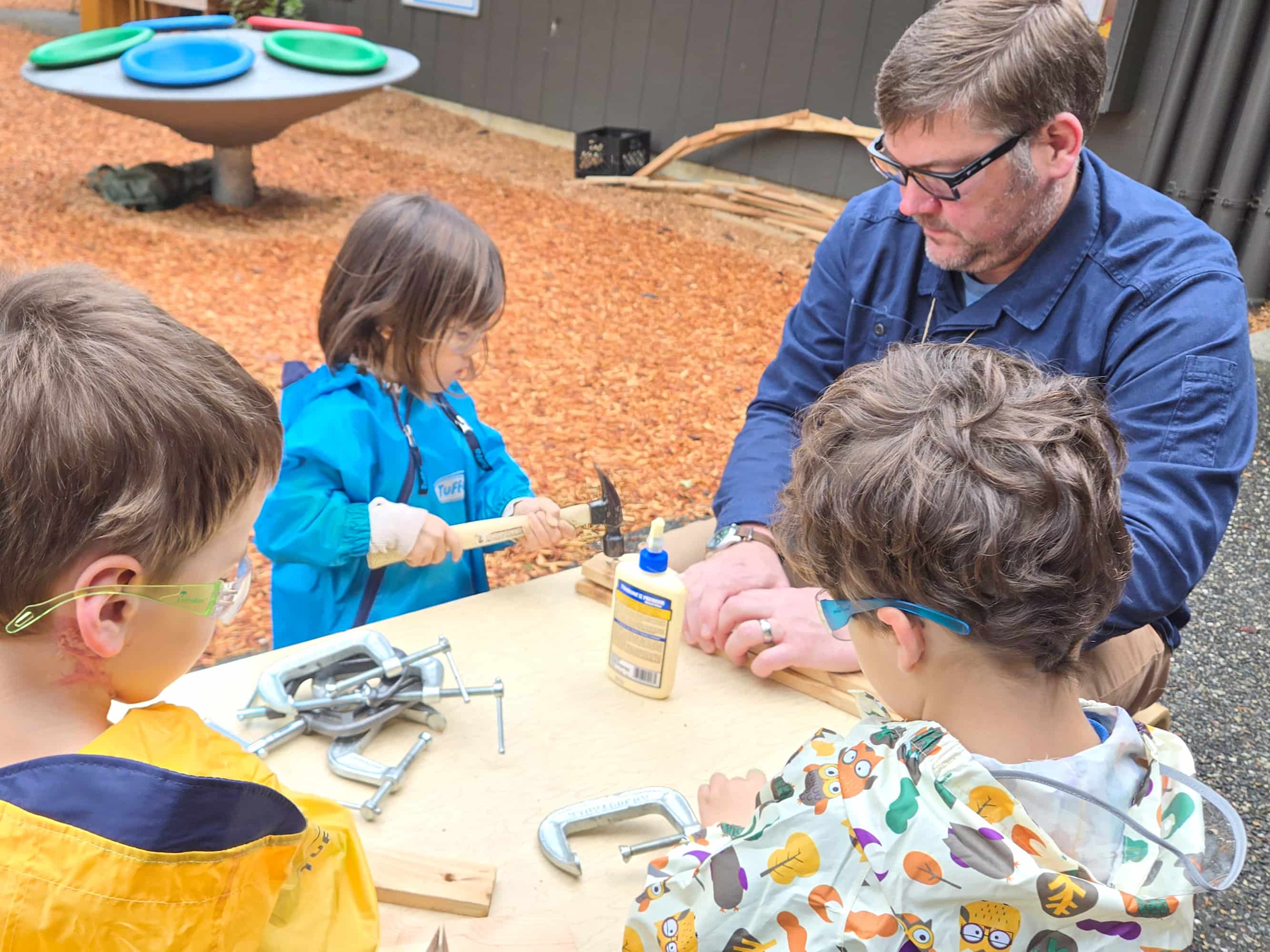 Children doing a woodworking project.
