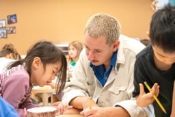 Student and teacher working together at a classroom table